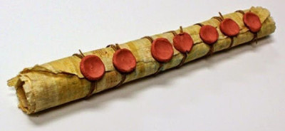 An ancient scroll sealed with seven wax seals, reminiscent of historical biblical manuscripts, displayed on a white background.