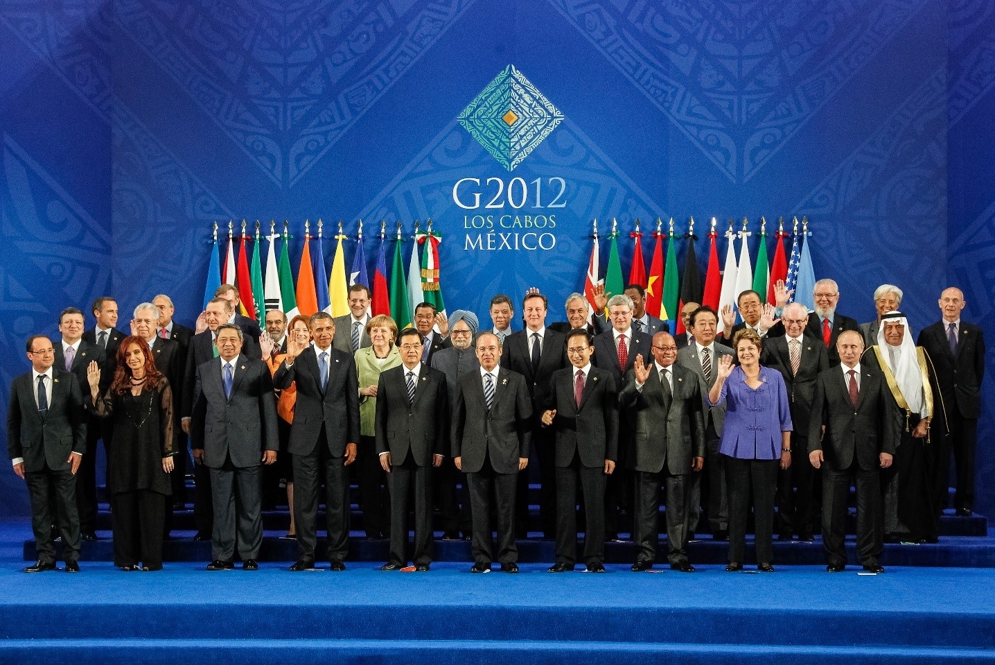 Group photo of global leaders at the G20 summit in Los Cabos, Mexico, in 2012, standing in two rows with a backdrop displaying the event's logo and multi-national flags.