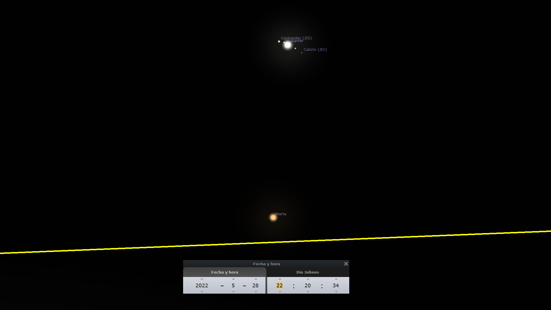Imagen astronómica mostrando Júpiter y sus lunas Ganímedes y Calisto, junto con el planeta Marte, sobre un fondo negro estrellado. En la parte inferior se visualiza una barra de herramientas con datos de fecha y hora marcando el 28 de mayo de 2022 a las 22:20:34.