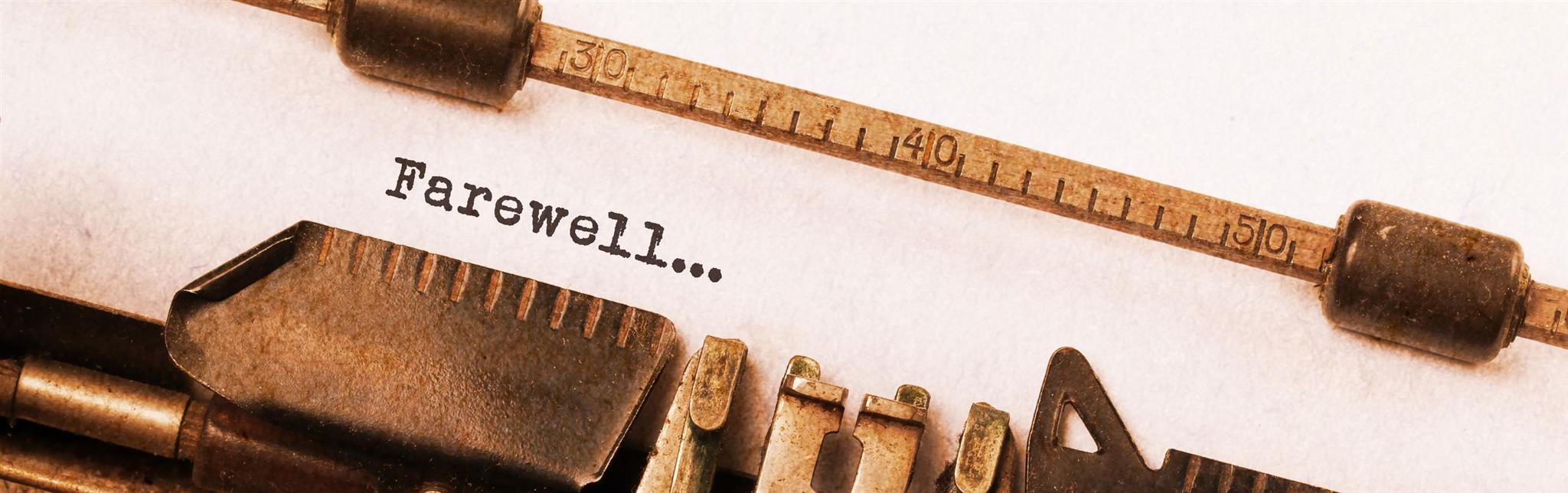 A close-up image of a vintage typewriter roller displaying the word "Farewell..." typed on a piece of paper, flanked by the aged, metallic parts of the typewriter including levers and a numbered ruler.