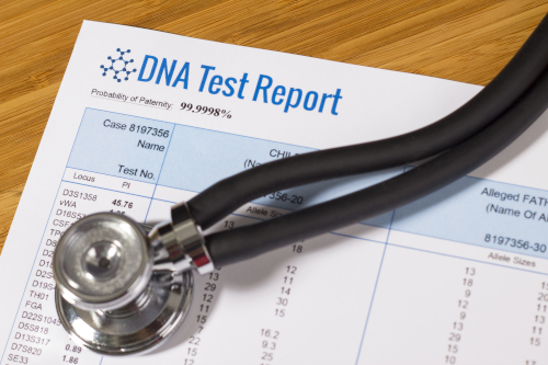 A DNA test report showing a 99.999% probability of paternity, lying on a wooden surface with a stethoscope placed on top of it.