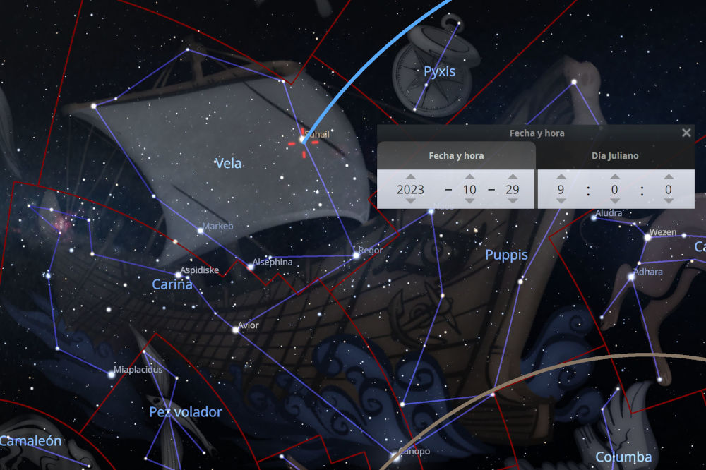 Imagen de un software de observación de estrellas mostrando varias constelaciones y estrellas en el cielo nocturno. Se observan líneas rojas y azules delineando diferentes agrupaciones de estrellas, acompañadas de etiquetas con sus nombres científicos. Un cuadro de diálogo en la esquina superior derecha muestra la fecha y hora y el día juliano, indicando el 29 de octubre de 2023.
