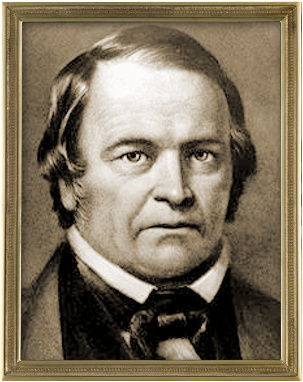 Sepia-toned portrait of a middle-aged man with a stern expression. He has short, dark hair, is wearing a dark suit with a bow tie, and is framed in an ornate golden frame. The background is plain, emphasizing the subject.