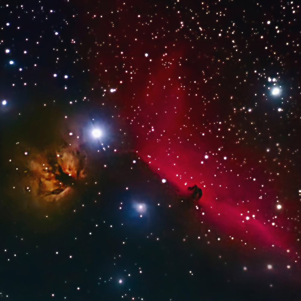 A captivating image of a celestial scene showcasing a vibrant contrast between a dense field of stars and a vivid nebula. The nebula glows with a deep red hue, highlighted by brighter stars and cloud formations that reveal intricate details of cosmic activity.