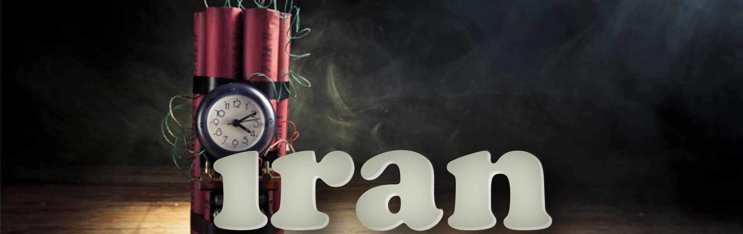 A conceptual image featuring a series of red dynamite sticks tied together with a black analog clock set to approximately ten minutes past nine, wrapped in green wires, on a dark smoky background behind large letters spelling "Iran."