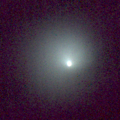 An astronomical image displaying a bright celestial body surrounded by a diffuse halo of light, radiating amidst a deep space backdrop.