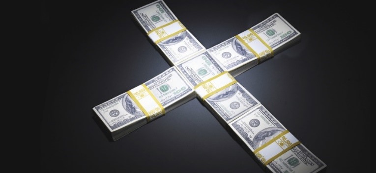 Bundles of US dollar bills arranged in a cross-like configuration on a dark surface, symbolizing intersections of value in a global economy.