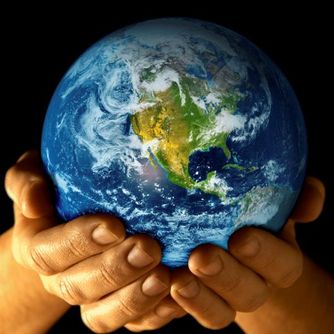 A pair of hands cradling a realistic, detailed model of Earth, showing predominantly the continents of North and South America surrounded by vast blue oceans.