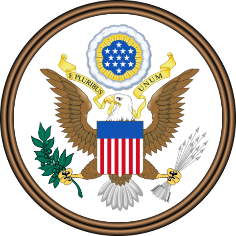 An emblem featuring a bald eagle with outstretched wings, clutching an olive branch and a bundle of arrows. The eagle bears a shield with red and white stripes and a blue chief. Above the eagle, a yellow ribbon bears the motto "E Pluribus Unum," and a constellation of stars within a blue cloud is encircled by a golden glory.