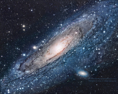 A detailed image of a galaxy viewed edge-on, showcasing a brilliant core surrounded by vast, star-filled spiral arms, interspersed with dark cosmic dust lanes.