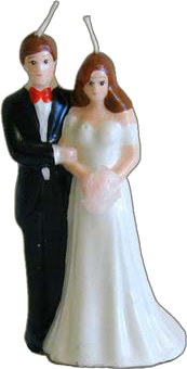 A wedding cake topper featuring a couple, with a man dressed in a black suit and red bow tie and a woman in a long white dress, both standing side by side.