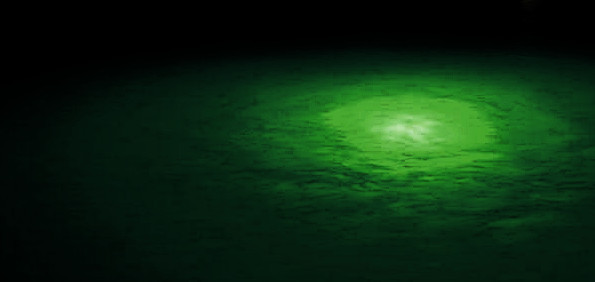 A glowing green nebula-like formation spreads across a dark background, resembling an auroral effect often seen in celestial phenomena.
