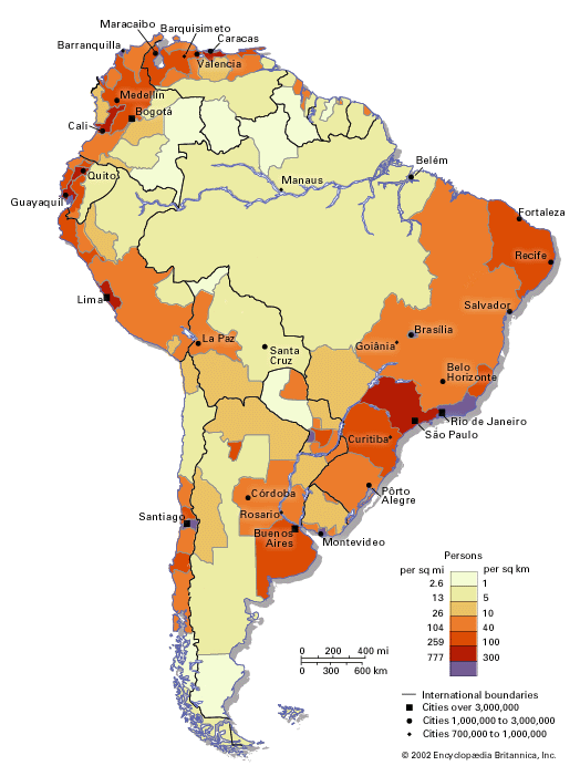 A color-coded demographic map of South America highlighting population density in various regions. Shades range from light yellow to dark red, representing population densities from lightest to heaviest. Major cities are marked and labeled, such as Buenos Aires, São Paulo, and Bogotá. A scale in the corner provides distances in miles and kilometers, while a legend explains the color shading in terms of population per square mile and per square kilometer.
