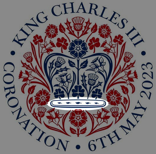 Emblem featuring a heraldic shield adorned with various floral motifs in red and blue, circled by the text "King Charles III, Coronation, 6th May 2023" set against a gray background.