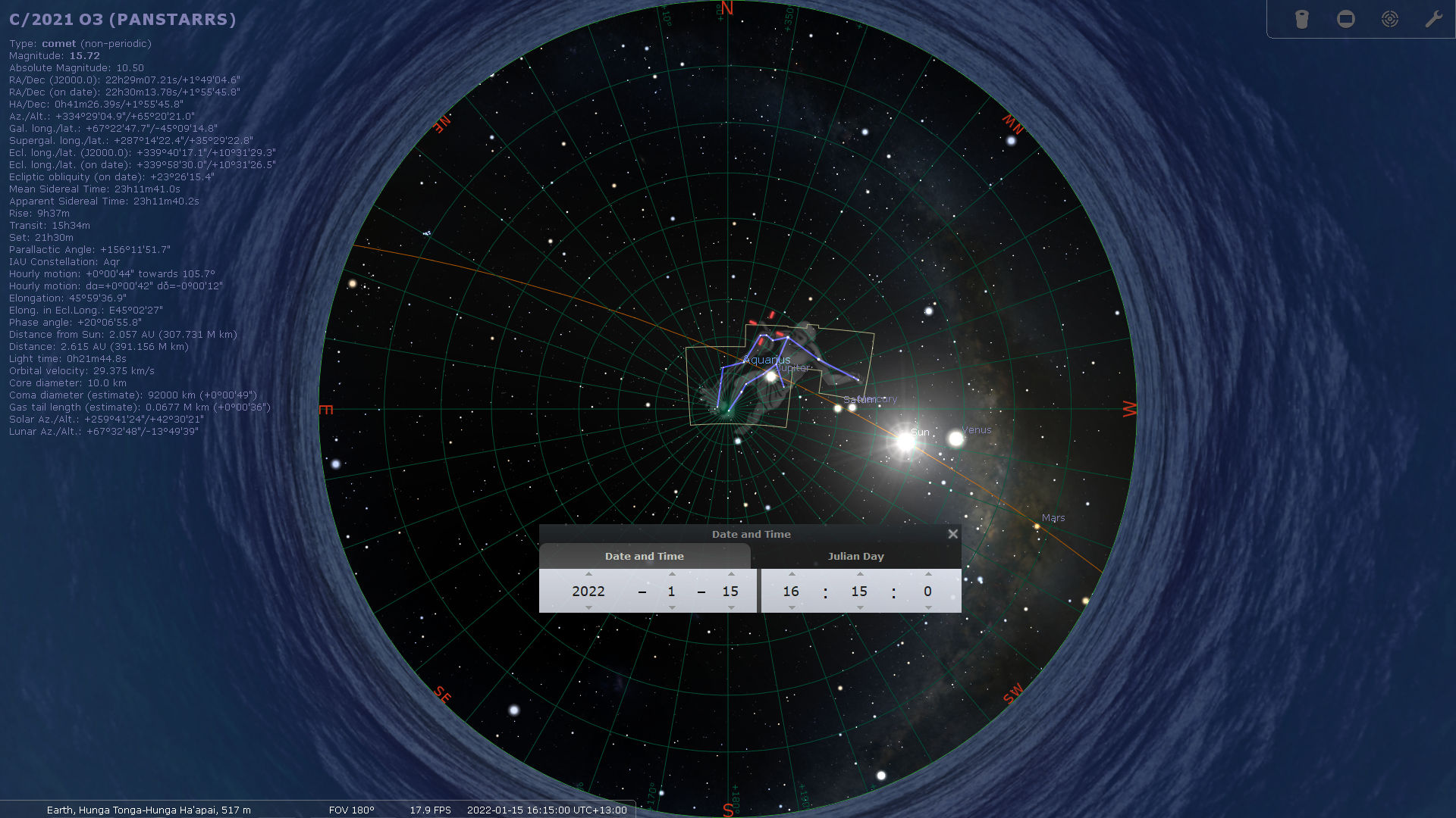 An astronomical software interface displaying a non-periodic comet named C/2021 O3 (PANSTARRS) located in the night sky, shown with celestial grid lines and coordinates. The image includes detailed data about the comet’s position, brightness, and trajectory. Background stars, several planets, and labels for the cardinal directions are also visible. The display is set against a backdrop simulating the Earth's atmosphere at the edge.