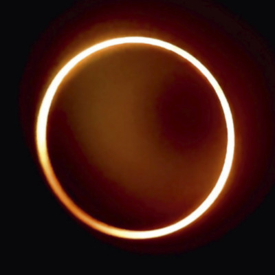 A celestial event showing a solar eclipse with a prominent ring of sunlight outlining the obscured Sun.