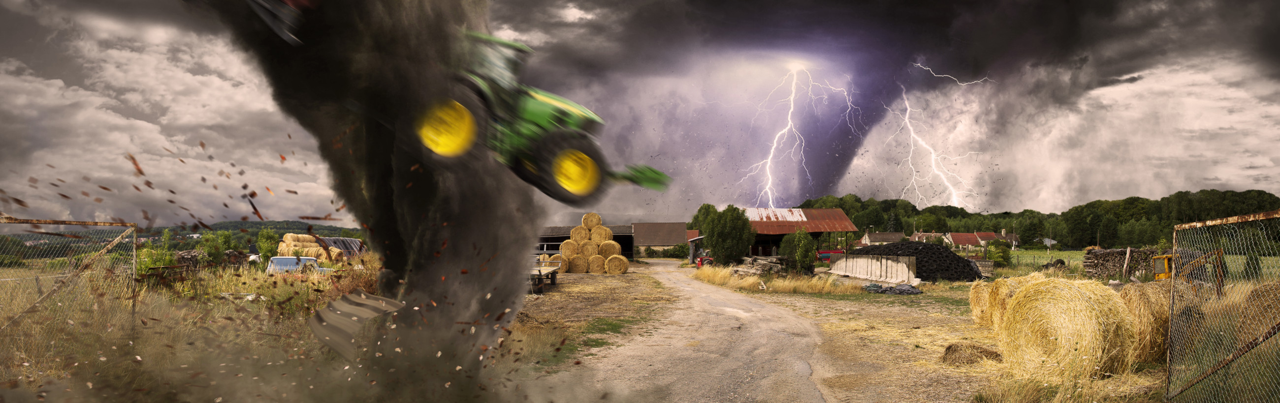 A dynamic rural scene featuring a storm with multiple lightning strikes in the backdrop. A tornado in the foreground lifts a green tractor, scattering leaves and debris. The farm shows hay bales, sheds, and a dirt track, exhibiting a typical farm setting under a tumultuous sky.