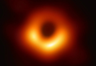 A blurred image of a celestial event featuring a glowing astronomical body with intense light surrounding a central dark void, reminiscent of archival depictions of the heavenly Mazzaroth.