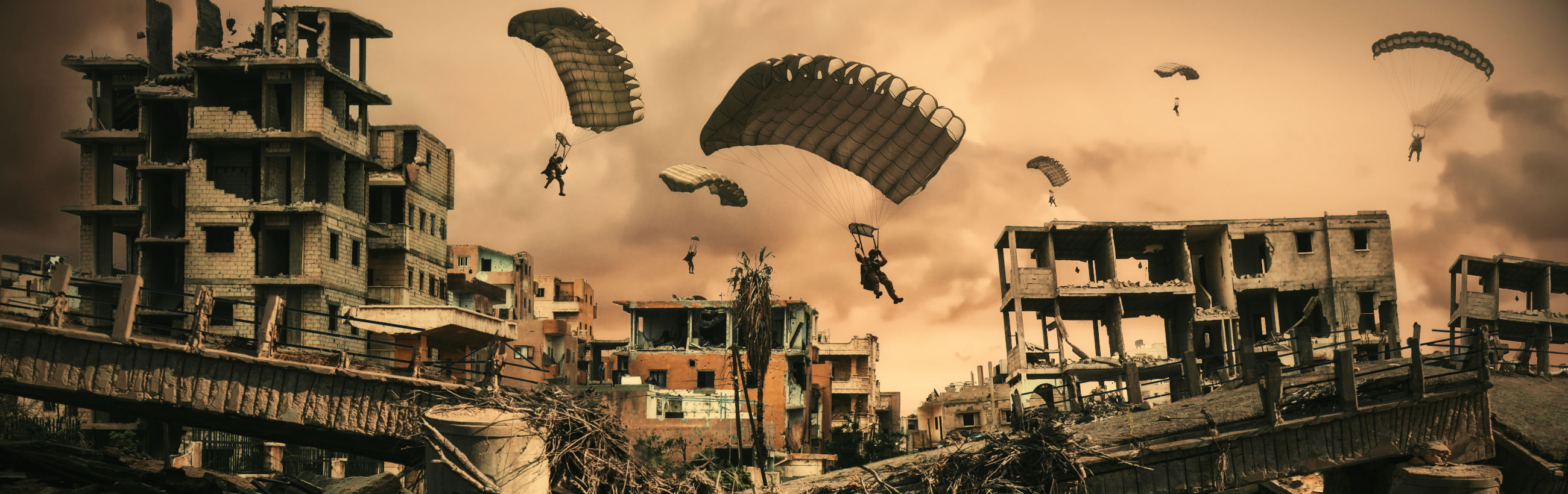 A panoramic view of a devastated cityscape under a cloudy sky, with buildings in ruin and debris scattered around. Multiple individuals are parachuting into the area, descending towards the wreckage.