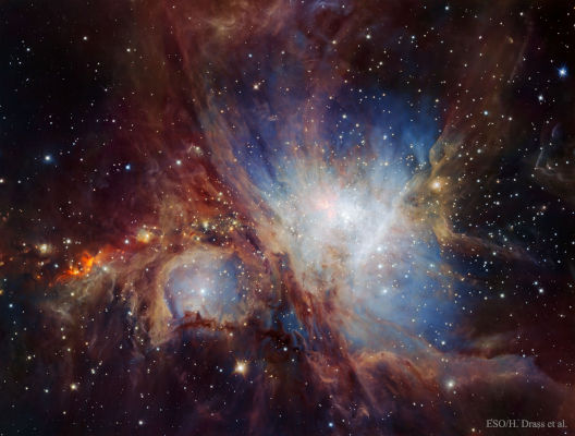 A vivid astronomical image displaying a complex and colorful interstellar nebula with swirling clouds of gas and dust illuminated by bright stars. The celestial environment encapsulates the magnificence and vastness of the cosmos.