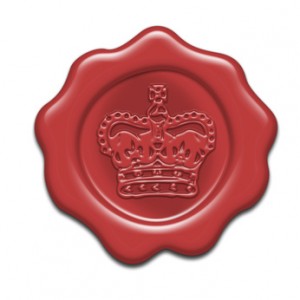 A detailed red wax seal embossed with a regal crown design.