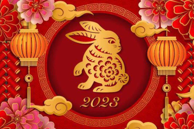 An ornate illustration features a golden rabbit surrounded by decorative elements including flowers and a lantern, set against a deep red background with the year 2023 prominently displayed.